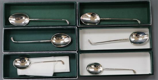 Six boxed silver golf club handled teaspoons.
